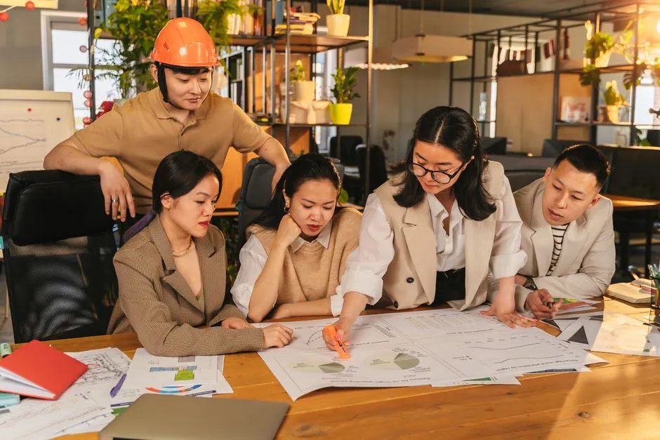 Diverse group collaborating on project planning in a modern office setting.
